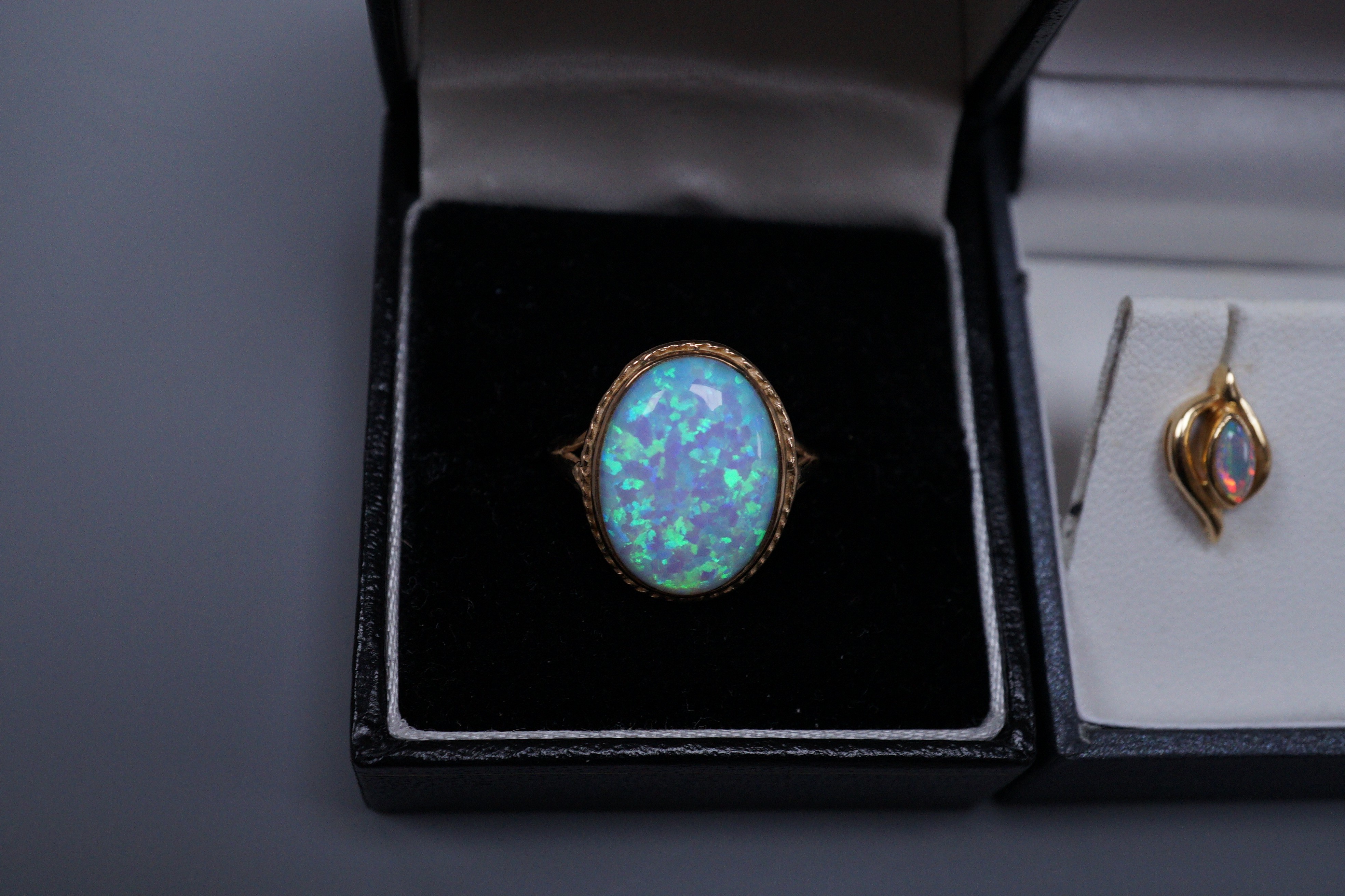 A 9ct gold white opal doublet ring, size O and a pair of white opal mounted ear studs